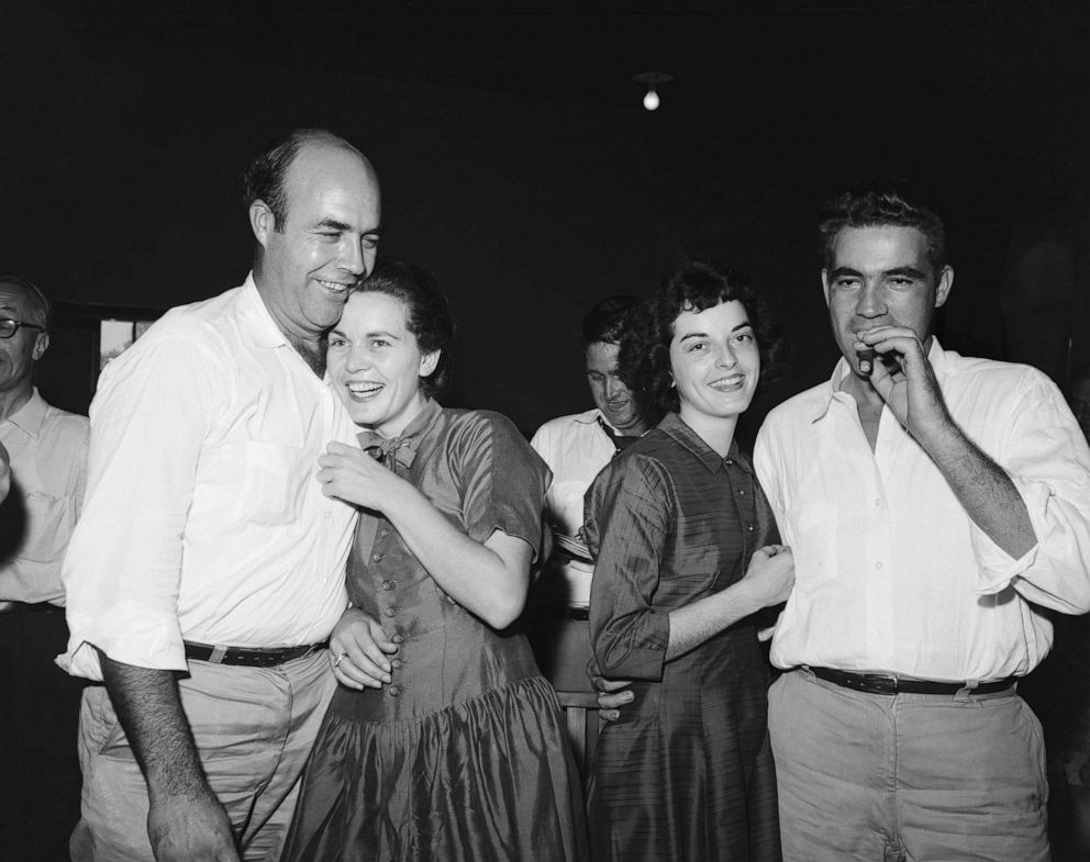 PHOTO: After their acquittal in the Emmett Till trial, defendant Roy Bryant (R), smokes a cigar as his wife happily embraces him and his half brother, J.W. Milam and his wife show jubilation. 