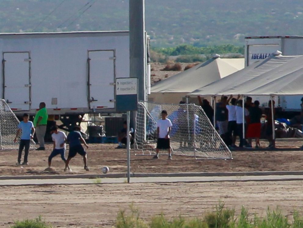 PHOTO: Children of detained migrants play soccer at a newly constructed tent encampment as seen through a border fence near the U.S. Customs and Border Protection port of entry in Tornillo, Texas, June 18, 2018.