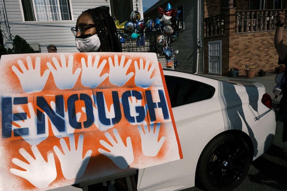 PHOTO: NEW YORK, NEW YORK - JUNE 09: Activists, politicians and community members and others attend a peace vigil to end gun violence in front of the house where a boy was recently shot in the Rockaway section of Queens  on June 09, 2021 in New York City.