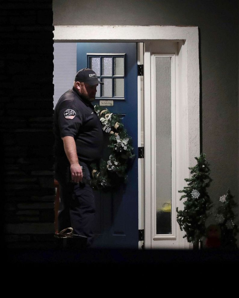 PHOTO: A law enforcement officer stands at the front door of the home in Enoch, Utah, where eight family members were found dead of gunshot wounds, Jan. 4, 2023.