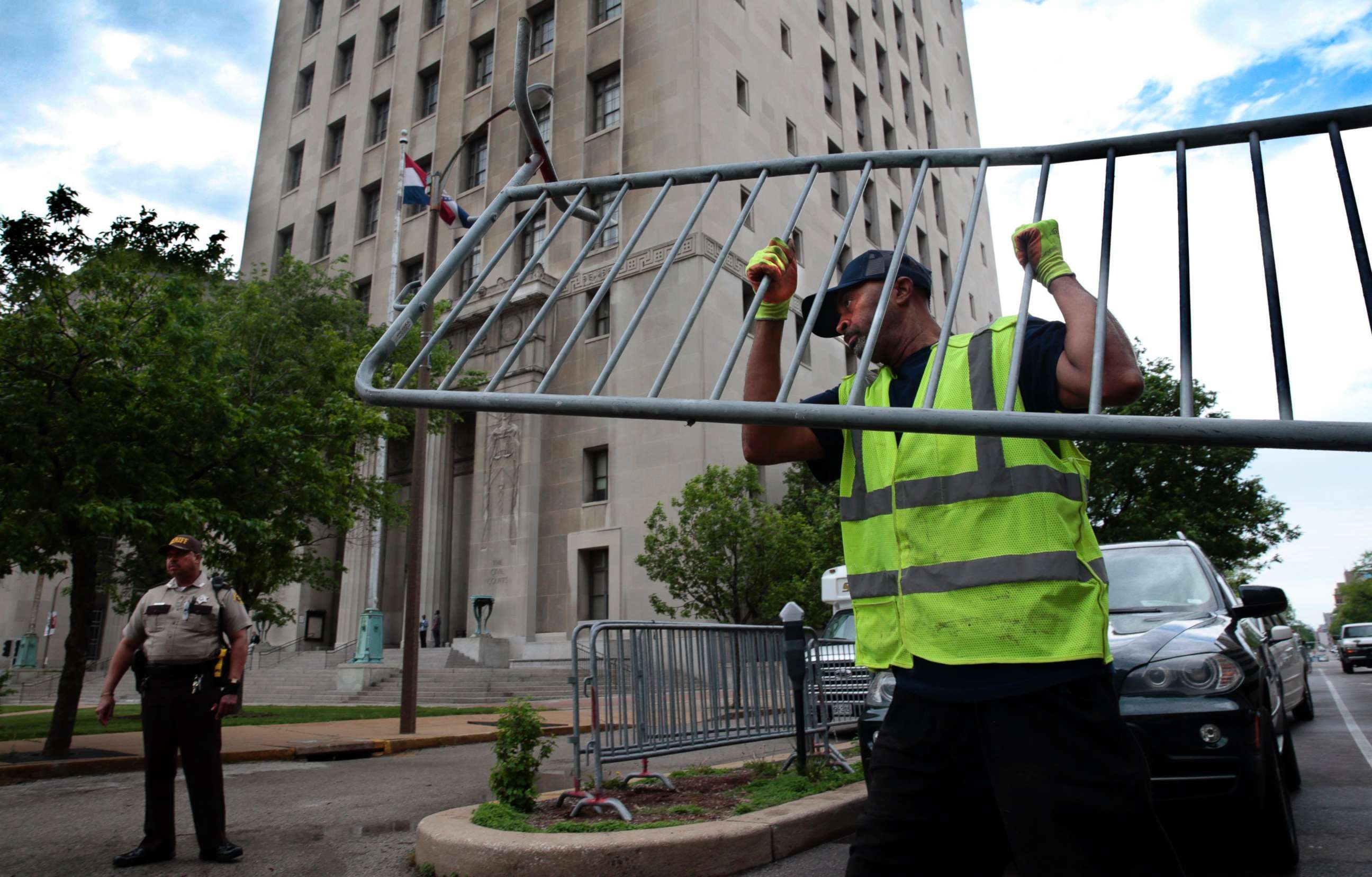 PHOTO: Members of the St. Louis streets department unload barricades on the side of the Civil Courts building in St. Louis, Mo., on May 9, 2018, in advance of the start of jury selection in the trial of Missouri Gov. Eric Greitens.