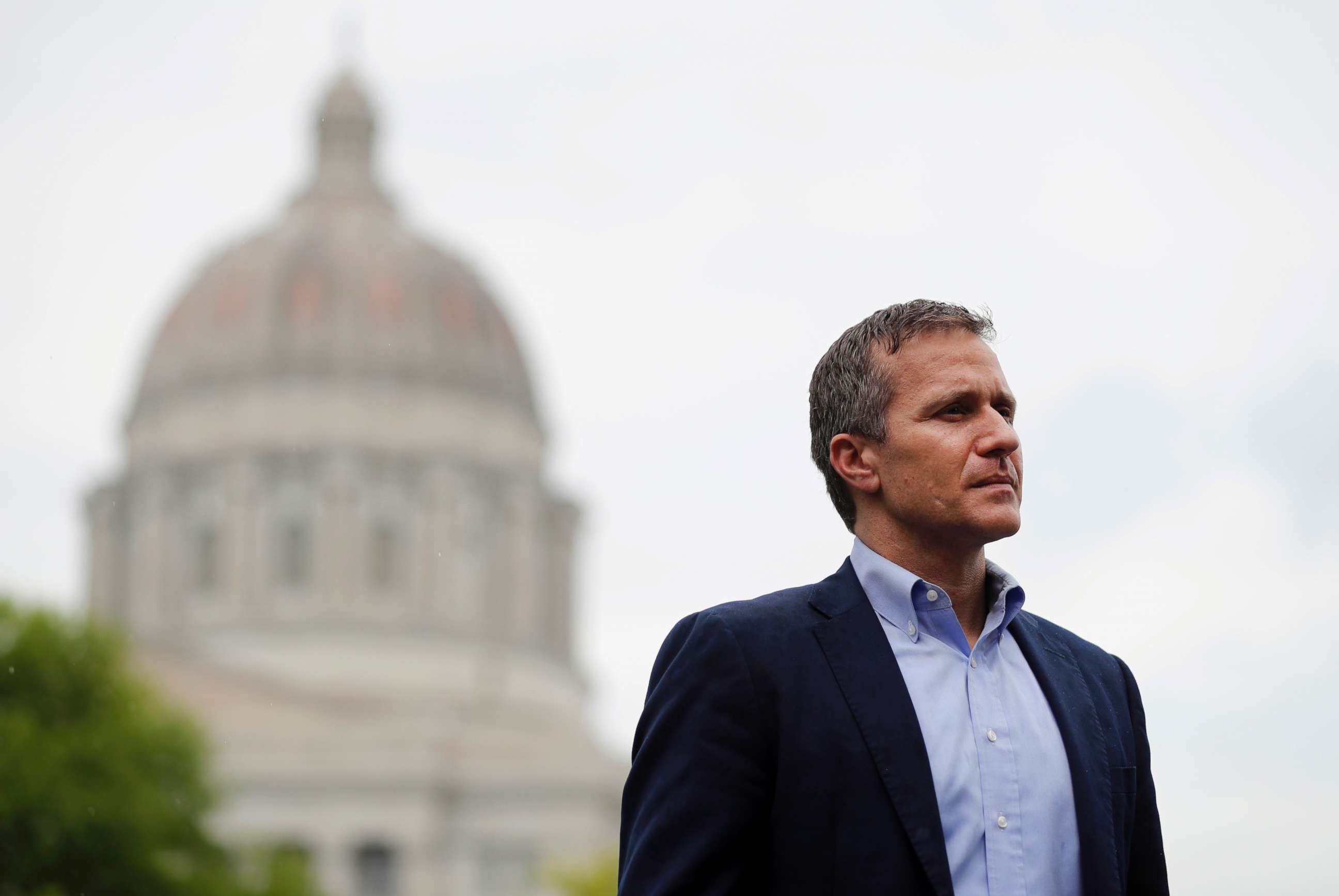 PHOTO: Missouri Gov. Eric Greitens stands off to the side before stepping up to the podium to deliver remarks to a small group of supporters near the capitol in Jefferson City, Mo., May 17, 2018, photo.