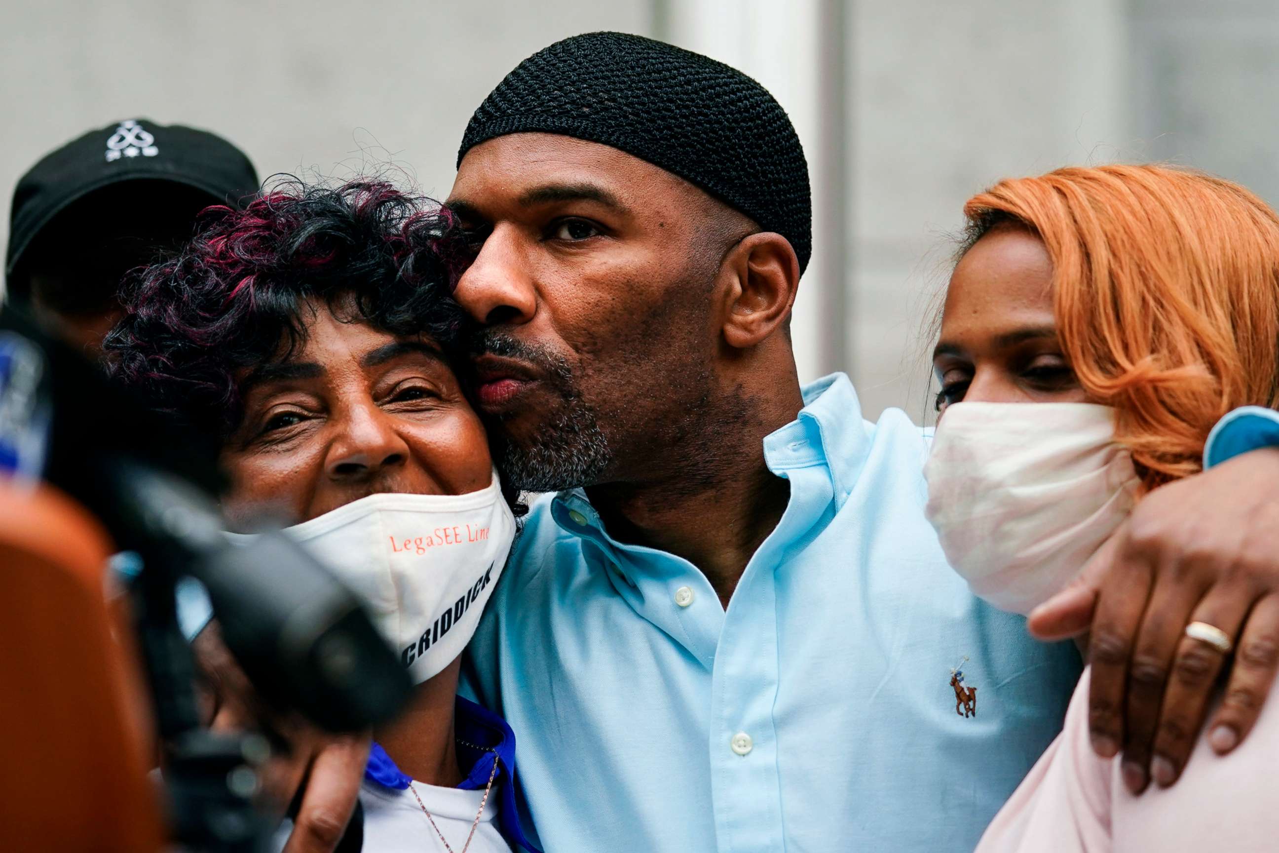 PHOTO: Eric Riddick, center, embraces his mother Christine Riddick, left, and wife Dana Baker-Riddick as they listen during a news conference in Philadelphia, Friday, May 28, 2021.