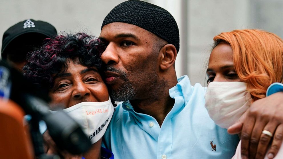 PHOTO: Eric Riddick, center, embraces his mother Christine Riddick, left, and wife Dana Baker-Riddick as they listen during a news conference in Philadelphia, Friday, May 28, 2021.
