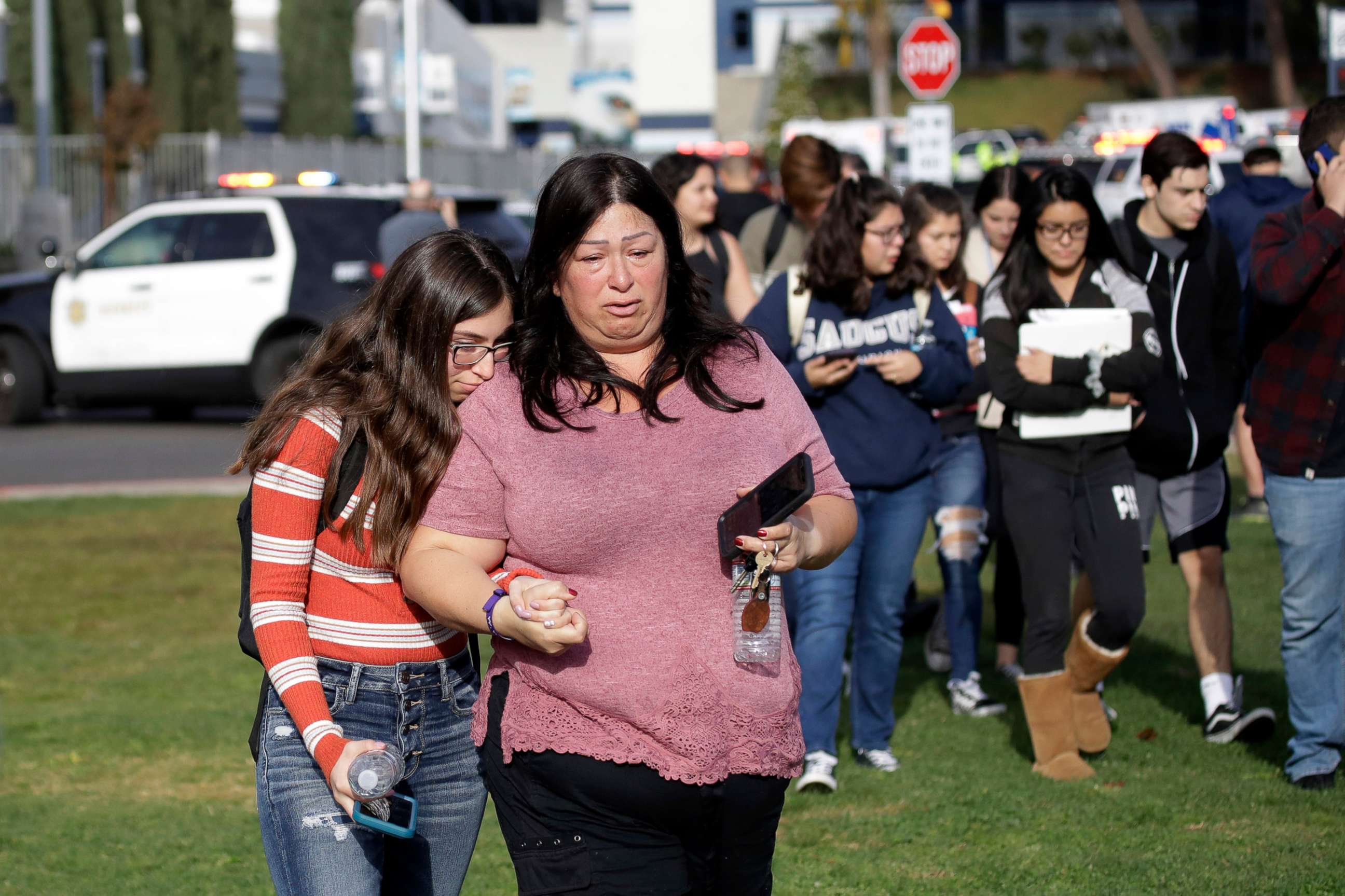 PHOTO: Students are escorted in a single file line as some parents pick them up outside of Saugus High School after reports of a shooting, Nov. 14, 2019, in Santa Clarita, Calif.
