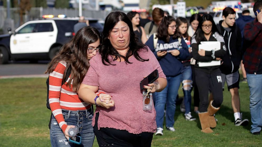 PHOTO: Students are escorted in a single file line as some parents pick them up outside of Saugus High School after reports of a shooting, Nov. 14, 2019, in Santa Clarita, Calif.
