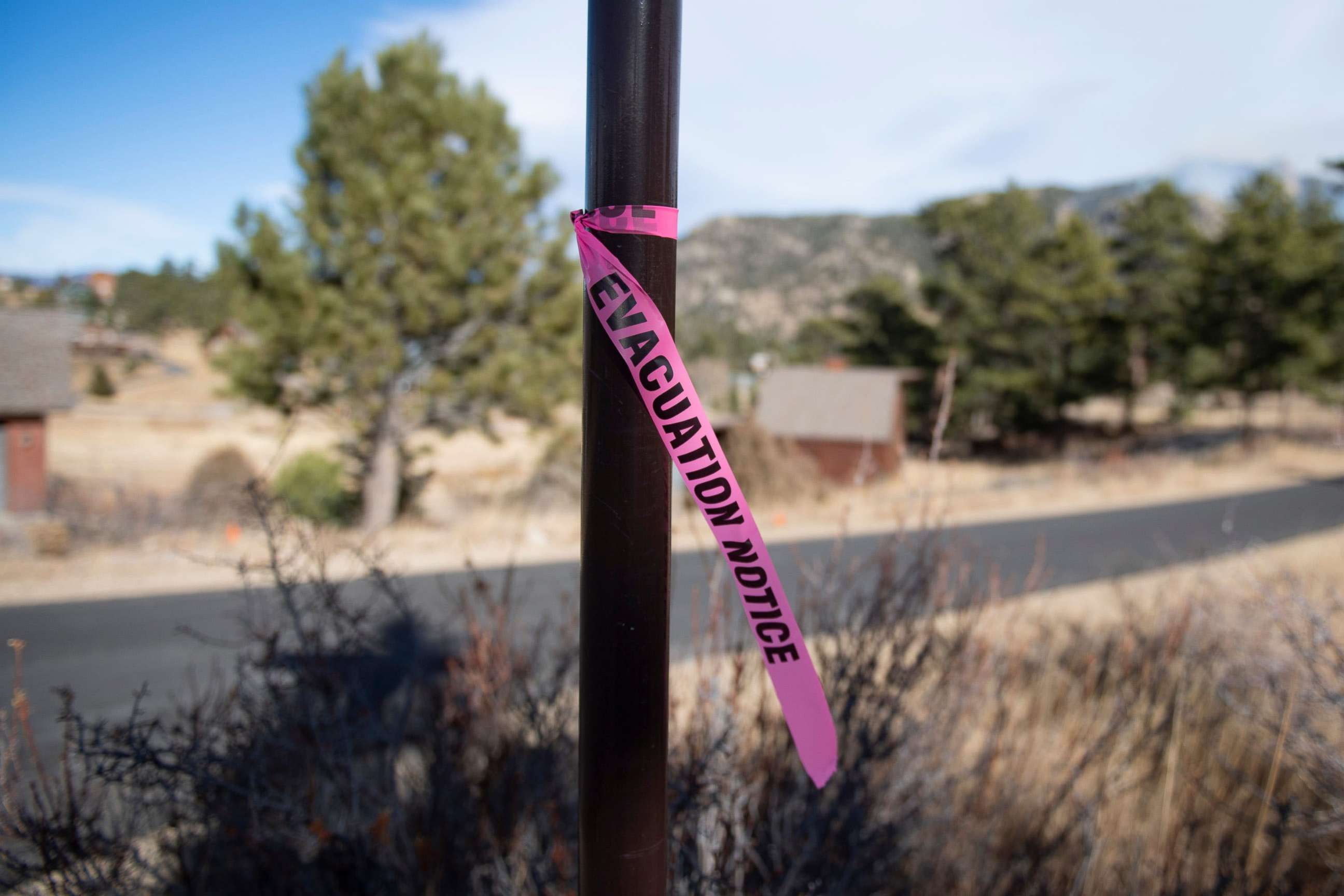 PHOTO: A evacuation notice flag is tied to a post, Nov. 16, 2021l, on Rockwood Lane in Estes Park, as wildfires forced evacuations.