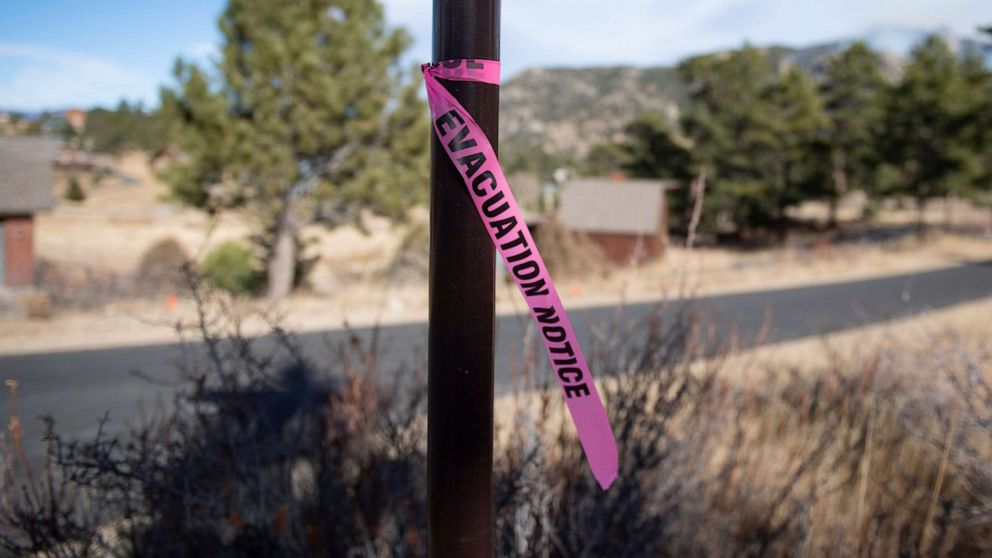PHOTO: A evacuation notice flag is tied to a post, Nov. 16, 2021l, on Rockwood Lane in Estes Park, as wildfires forced evacuations.