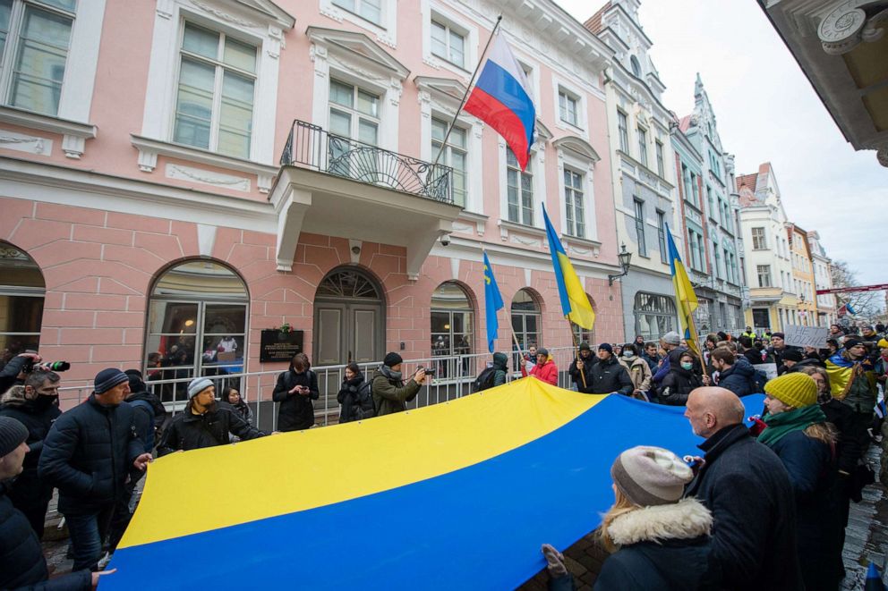 PHOTO: Demonstrators display a giant Ukrainian flag during a protest against Russia's invasion of Ukraine, on Feb. 24, 2022, in front of the Russian Embassy in Tallinn, Estonia.