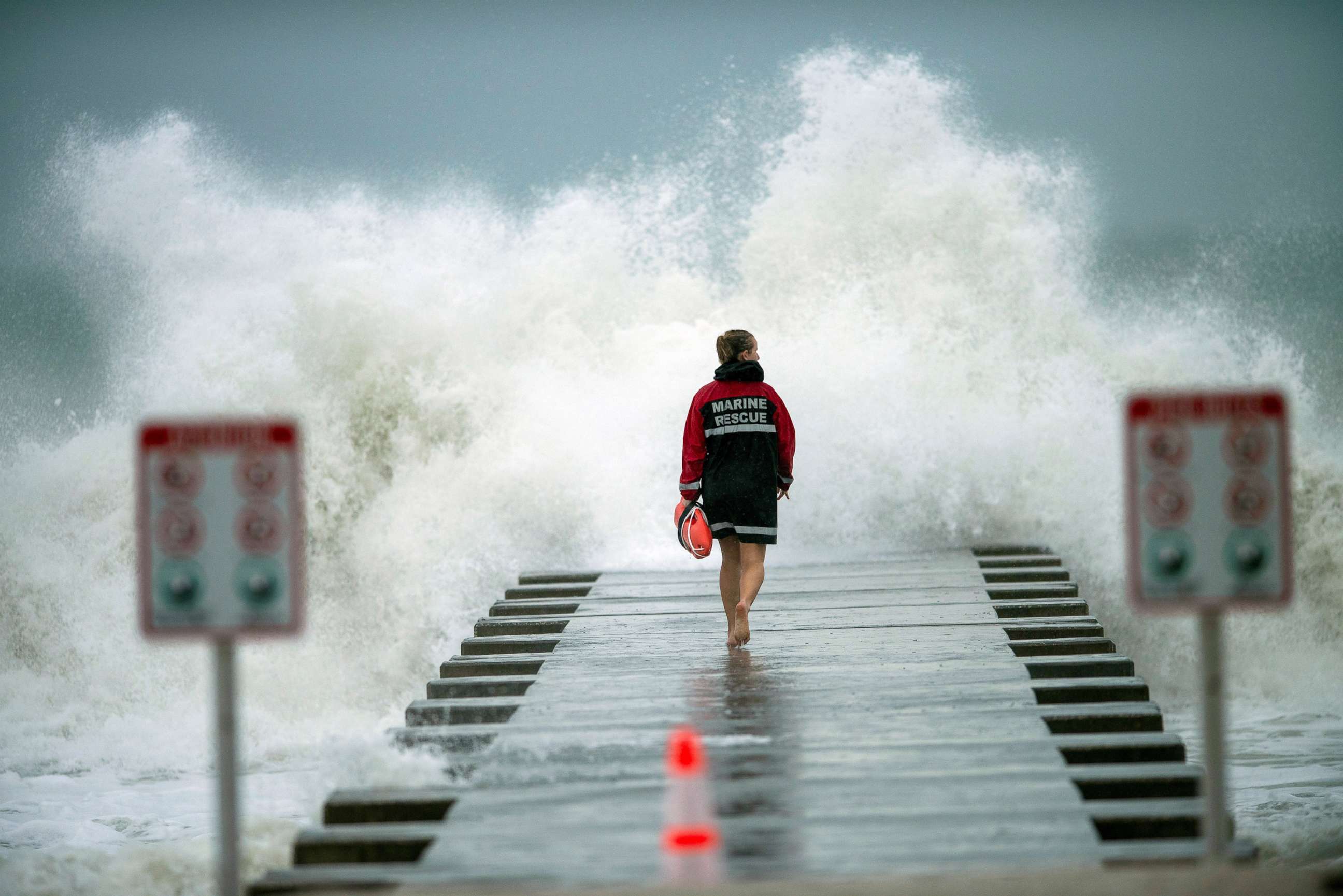 PHOTO: A lifeguard walks to the end of the jetty after closing it down to surfers before the arrival of Huricane Eta in Bradenton Beach, Fla, Nov. 11, 2020.