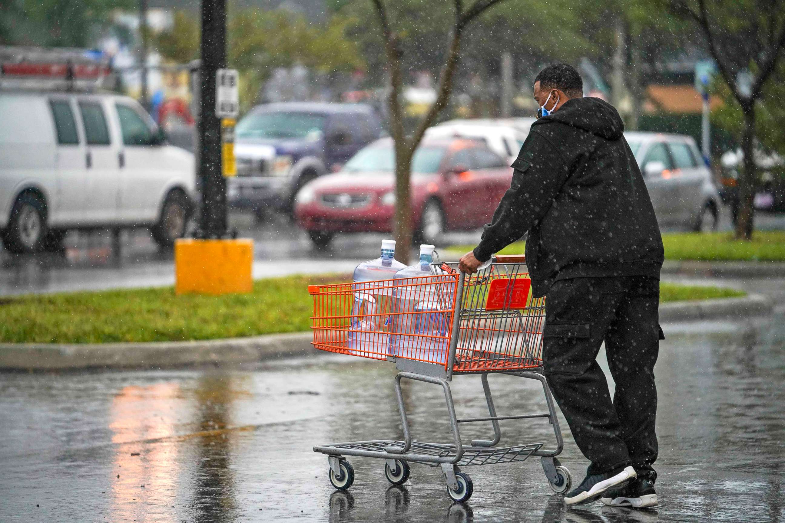 PHOTO: A man leaves The Home Depot after buying extra water in preparation for Hurricane Eta, on Nov. 11, 2020 in Tampa, Fla.