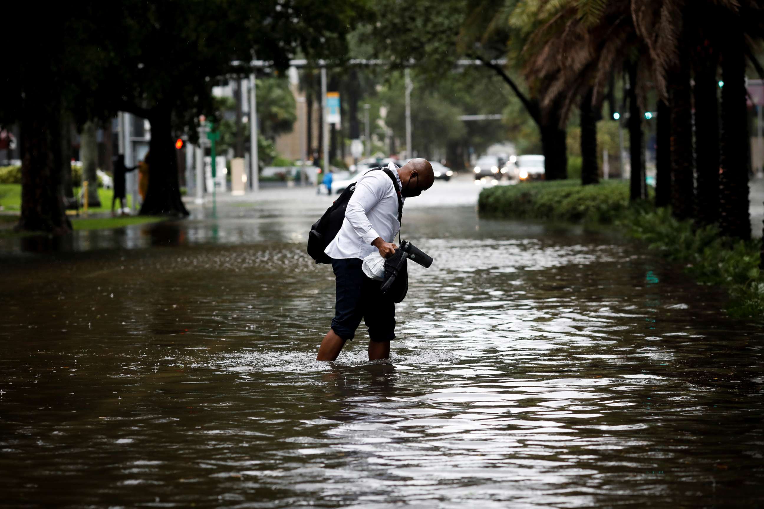 PHOTO: A man walks in floodwaters caused by Storm Eta in a street at the Brickell neighborhood in Miami, Nov. 9, 2020.