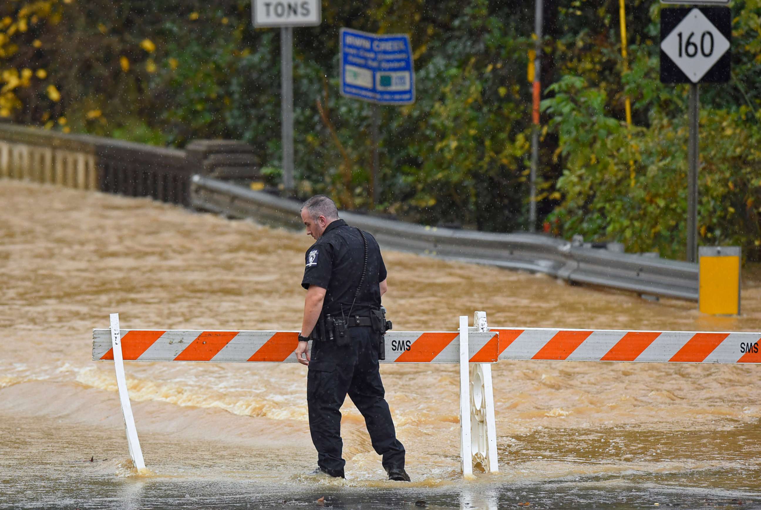 PHOTO: A Charlotte-Mecklenburg police officer blocks West Blvd. from local traffic as floodwater blocks the road in Charlotte, N.C., Thursday, Nov. 12, 2020.