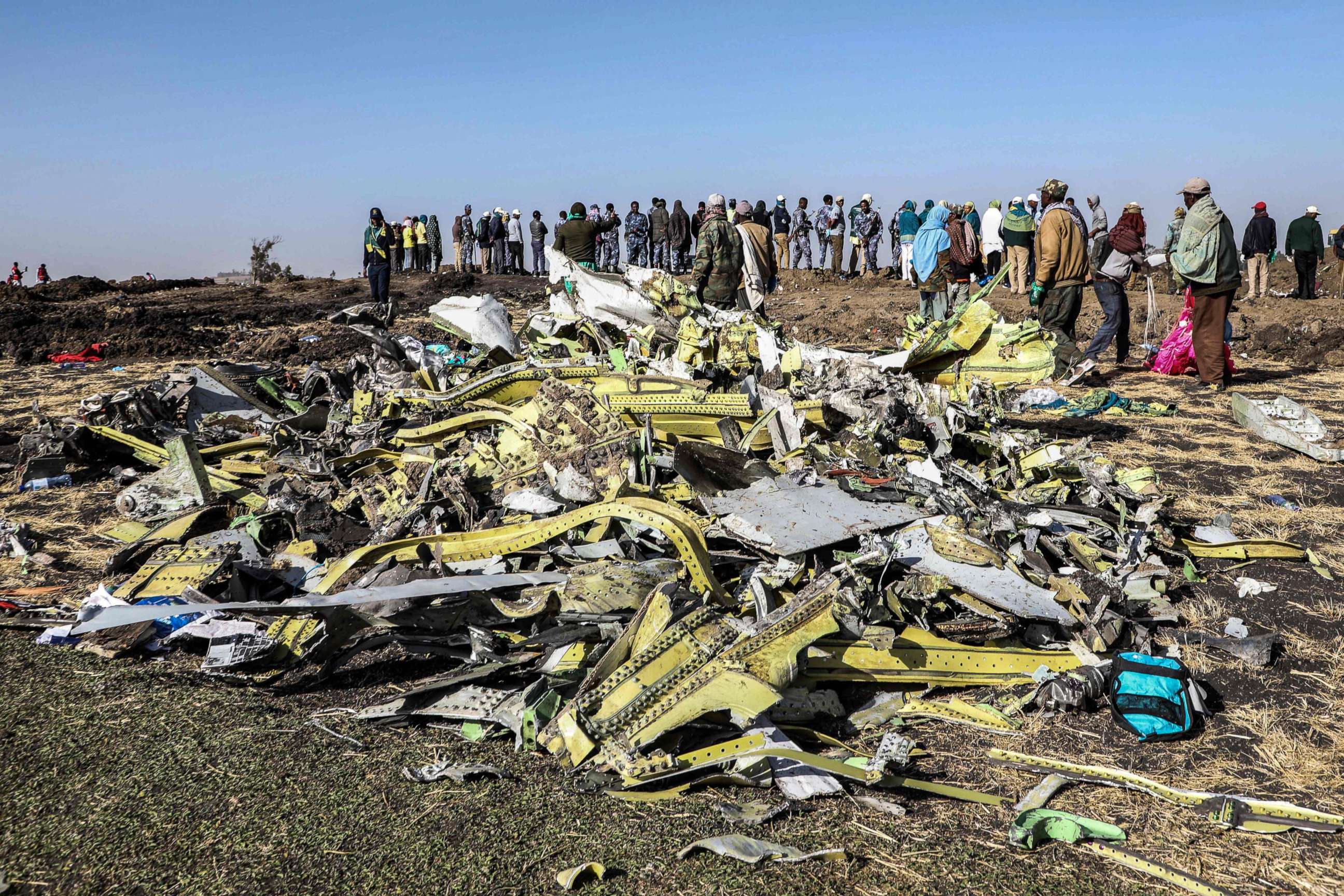 PHOTO: People stand near collected debris at the crash site of Ethiopia Airlines near Bishoftu, southeast of Addis Ababa, Ethiopia, March 11, 2019. 