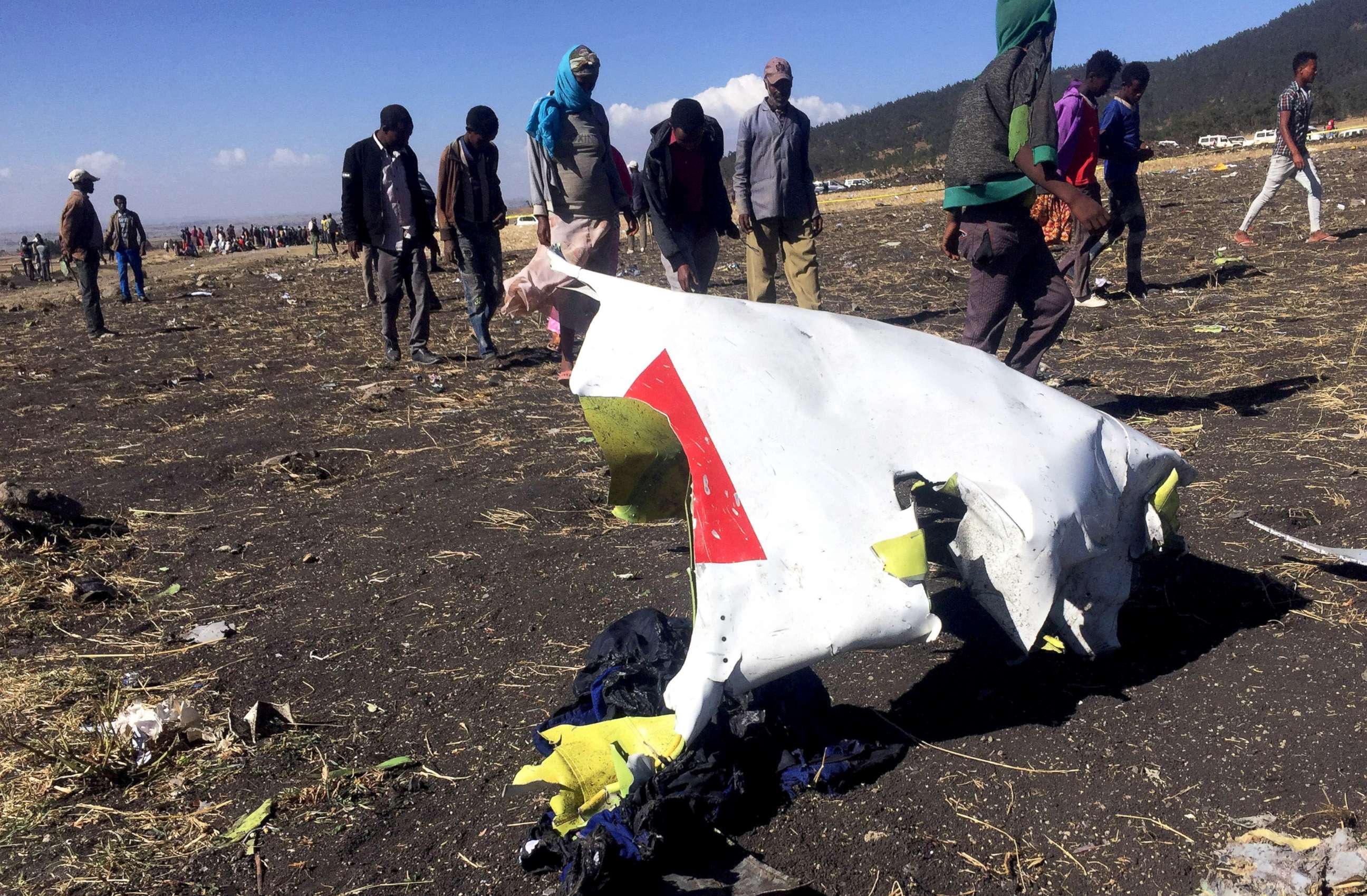 PHOTO: People walk past a part of the wreckage at the scene of the Ethiopian Airlines Flight ET 302 plane crash, near the town of Bishoftu, southeast of Addis Ababa, Ethiopia, March 10, 2019.