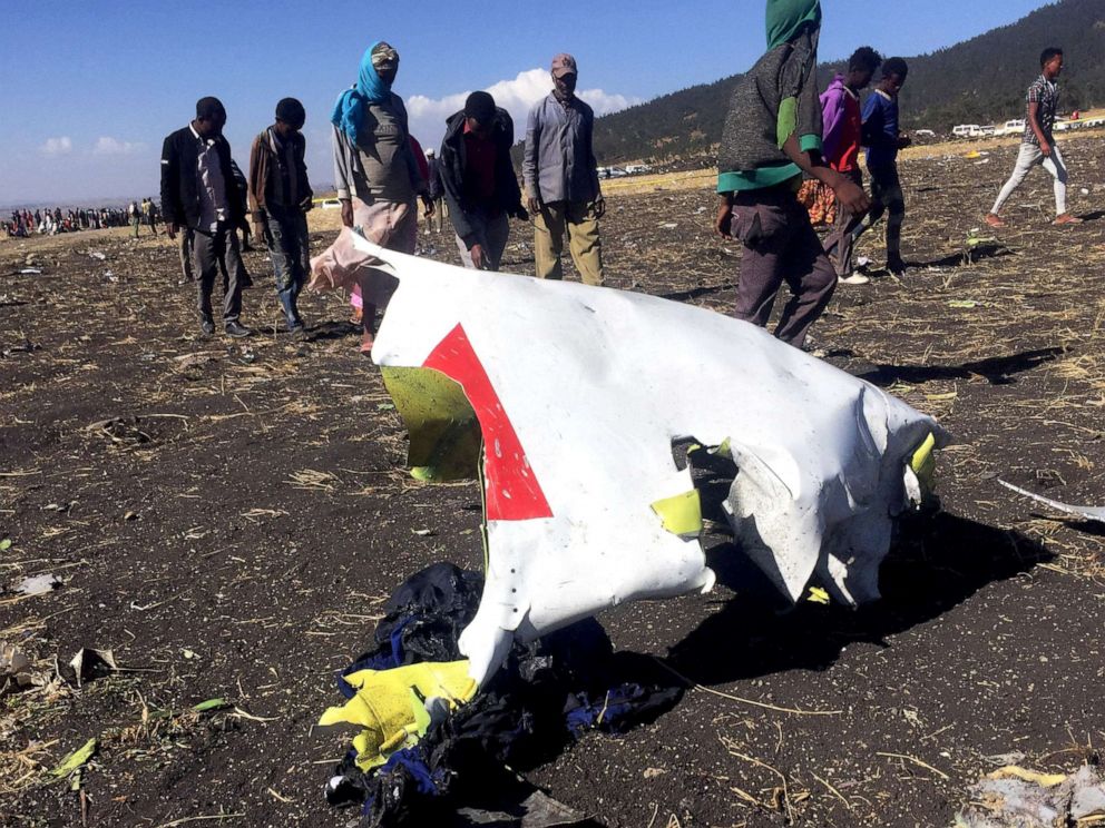 PHOTO: People walk past a part of the wreckage at the scene of the Ethiopian Airlines Flight ET 302 plane crash, near the town of Bishoftu, southeast of Addis Ababa, Ethiopia, March 10, 2019.