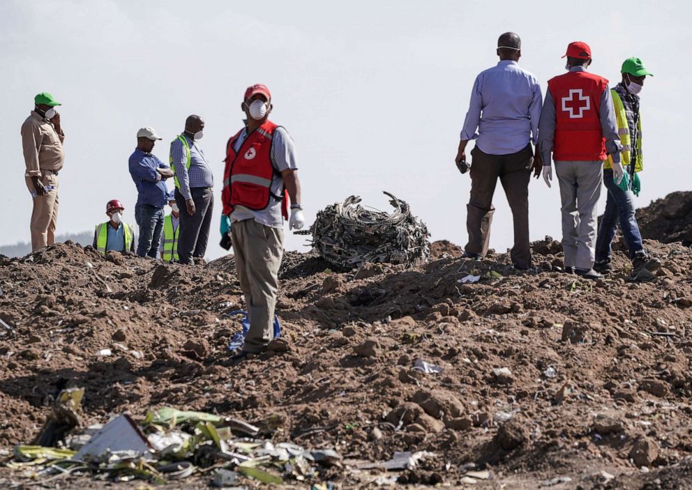 PHOTO: Investigators and recovery workers inspect a second engine after it was recovered from a crater at the scene of the Ethiopian Airlines Flight 302 crash on March 13, 2019, in Ejere, Ethiopia.