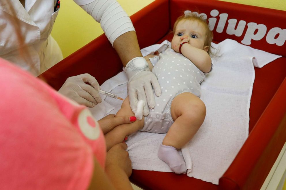 PHOTO: In this file photo, a child receives a vaccine in a hospital in Belgrade, Serbia, September 3, 2018.