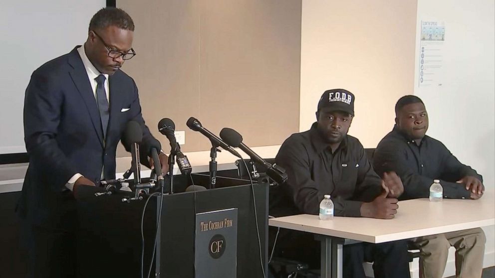 PHOTO: Witnesses Mike Perkins and Melvin Evans who were sitting in a car when Rayshard Brooks was shot to death in a Wendy's parking lot in Atlanta, wait to speak at a press conference, June 18, 2020, as their lawyer Shean Williams introduces them.