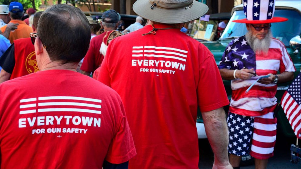 PHOTO: Two men wear 'Moms Demand Action for Gun Sense in America' T-shirts at a Fourth of July celebration in Santa Fe, July 4, 2017.
