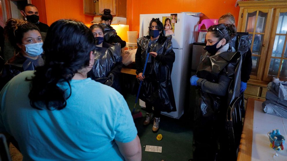 PHOTO: In this March 26, 2021, file photo, staff from La Colaborativa talk to a resident being evicted, as they pack her belongings in Chelsea, Mass. La Colaborativa offers to help them move, storing belongings and finding transitional housing.