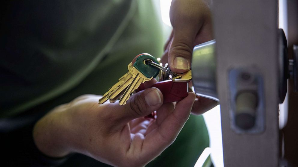PHOTO: An maintenance man changes the lock of an apartment after constables posted an eviction order on Oct. 7, 2020, in Phoenix, Arizona.