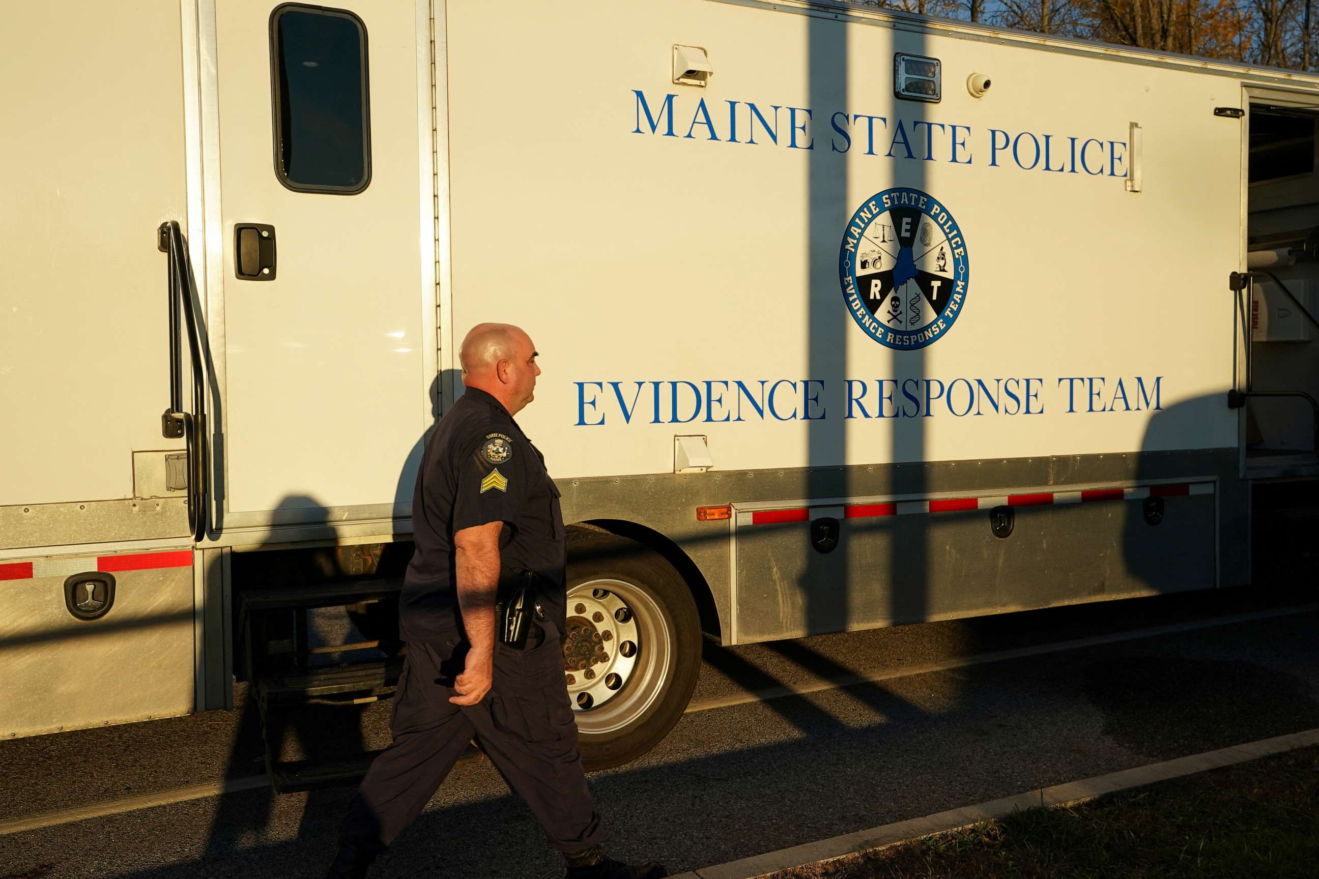 PHOTO: A member of law enforcement walks towards Maine State Police Evidence Response Team vehicle, near the Schemengees Bar & Grille Restaurant, one of the locations of the deadly mass shootings, in Lewiston, Maine, U.S., Oct. 28, 2023.