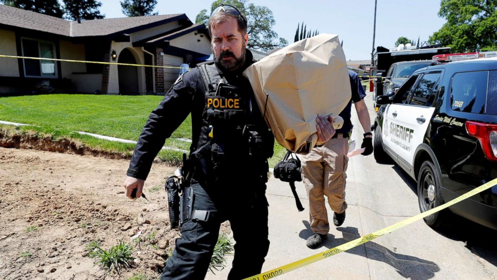 PHOTO: A police officer removes items in evidence bags from the home of Joseph James Deangelo, in Citrus Heights, Calif, April 26, 2018.
