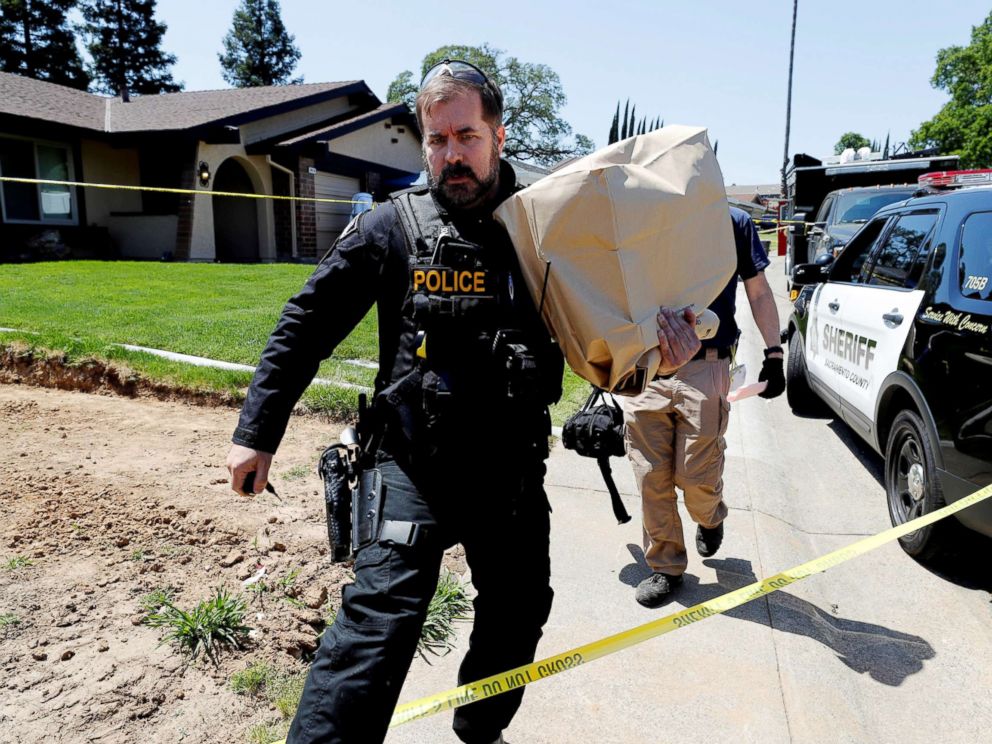 PHOTO: A police officer removes items in evidence bags from the home of Joseph James Deangelo, in Citrus Heights, Calif, April 26, 2018.