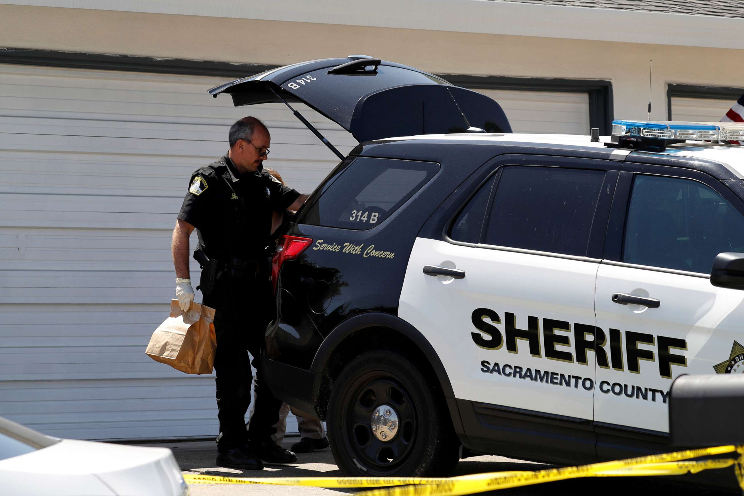 PHOTO: An investigator puts evidence bags in a sheriff's vehicle after removing them from the home of Joseph James Deangelo in Citrus Heights, Calif., April 26, 2018.