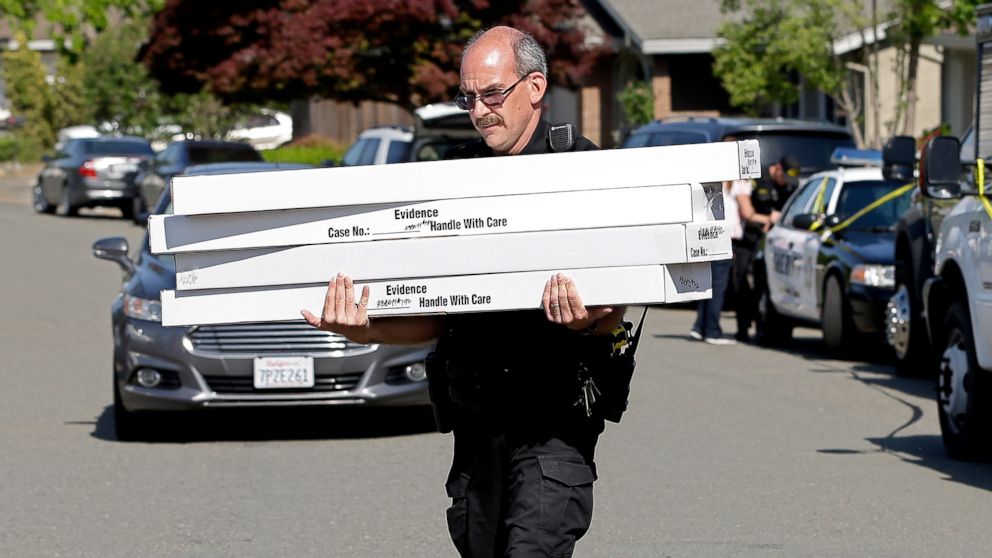 PHOTO: John Lopes, a crime scene investigator for the Sacramento County Sheriff's office, carries boxes of evidence taken from the home of murder suspect Joseph DeAngelo to a sheriff's vehicle, April 26, 2018, in Citrus Heights, Calif.