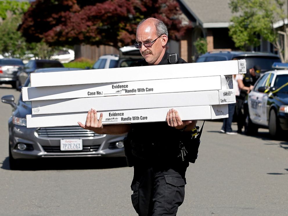 PHOTO: John Lopes, a crime scene investigator for the Sacramento County Sheriffs office, carries boxes of evidence taken from the home of murder suspect Joseph DeAngelo to a sheriffs vehicle, April 26, 2018, in Citrus Heights, Calif.