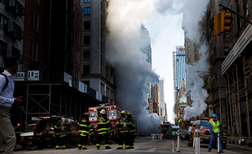PHOTO: Firefighters work on the scene of a high pressure steam explosion on Fifth Avenue in New York, July 19, 2018. 