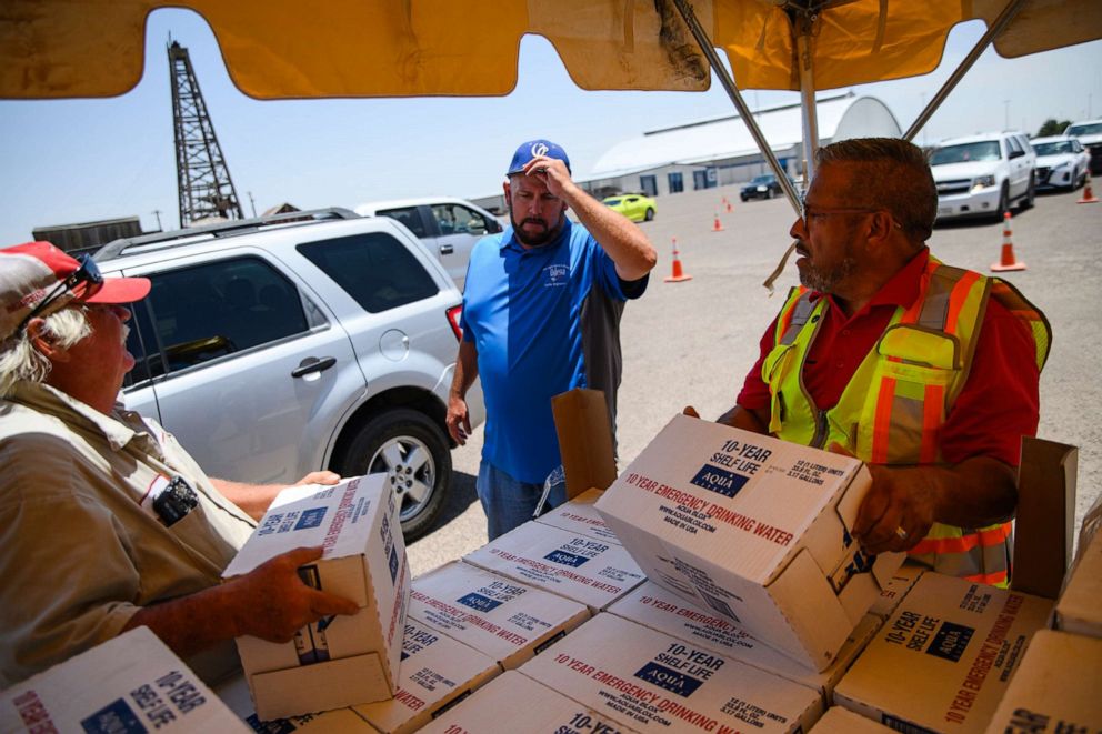 PHOTO: Volunteers begin to hand out 12-liter boxes of emergency drinking water to residents in need after a broken water main left the majority of Ector County without clean running water in Odessa, Texas, June 14, 2022.
