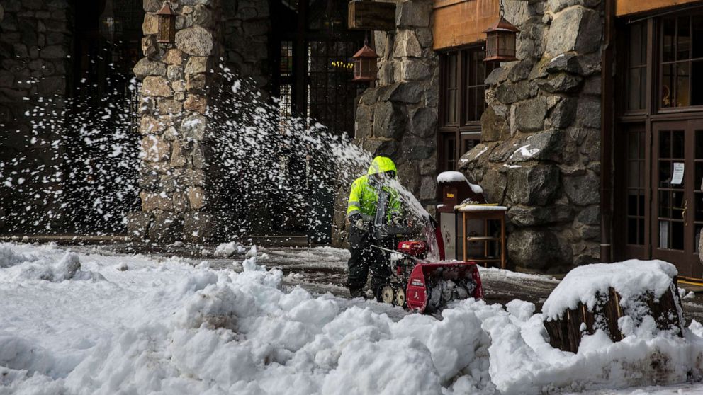 PHOTO: A worker snowplows sidewalks after major Pacific storm dumps a foot of in snow in Yosemite Valley and 8-10 feet of powder in the higher elevations of the Park and along the Sierra Nevada crest in Yosemite National Park, Calif. Dec. 16, 2021.