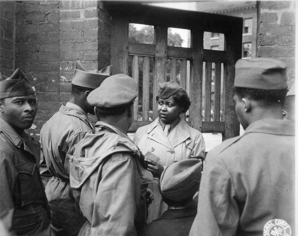 PHOTO: Private Ruth L. James cheks soldiers in during an "Open House" after the battalion had set up its facilities in Rouen, France. The 6888th Central Postal Battalion was the only all Black battalion in the WAC and was sent overseas during World War II