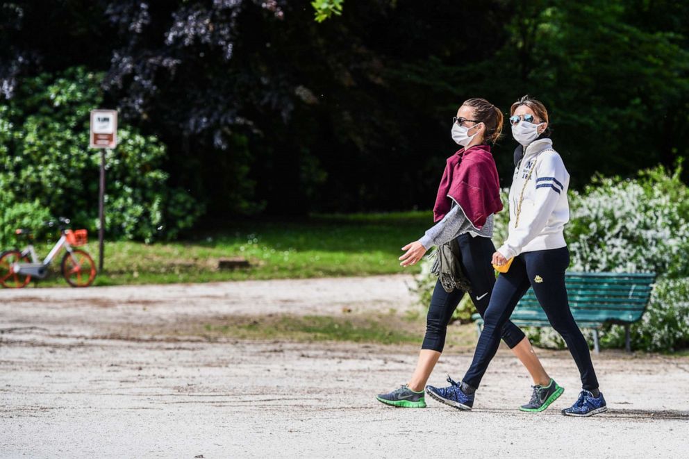PHOTO: Women walk in the Parco Sempione park, May 4, 2020 in Milan.