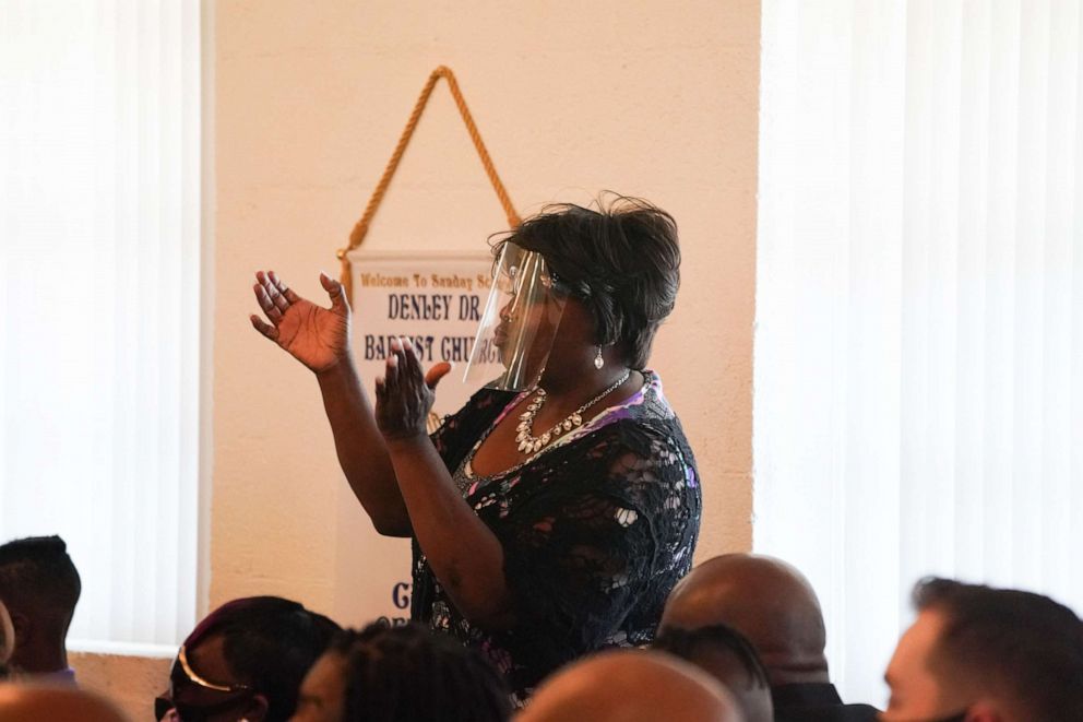 PHOTO: A family member wearing a face shield sings during a double funeral service for Lola M. Simmons-Jones and her daughter Lashaye Antoinette Allen, who both died of coronavirus, at the Denley Drive Missionary Baptist Church in Dallas on July 30, 2020.
