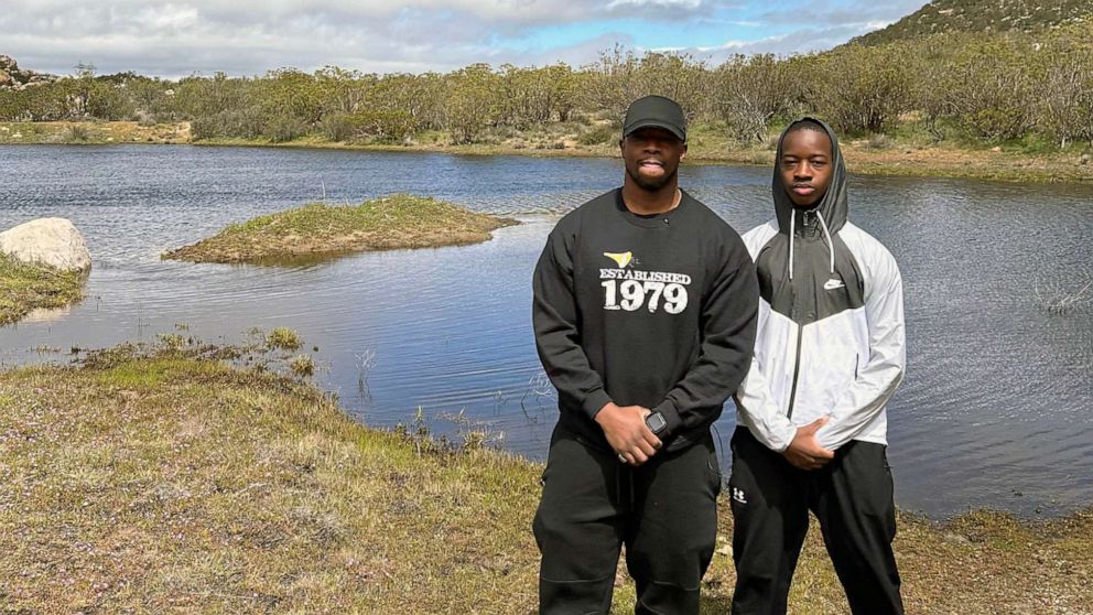 PHOTO: Faheem Muhammad and his son Faheem Ra'id Muhammad stand on the 40 acres Faheem Muhammad bought his son.