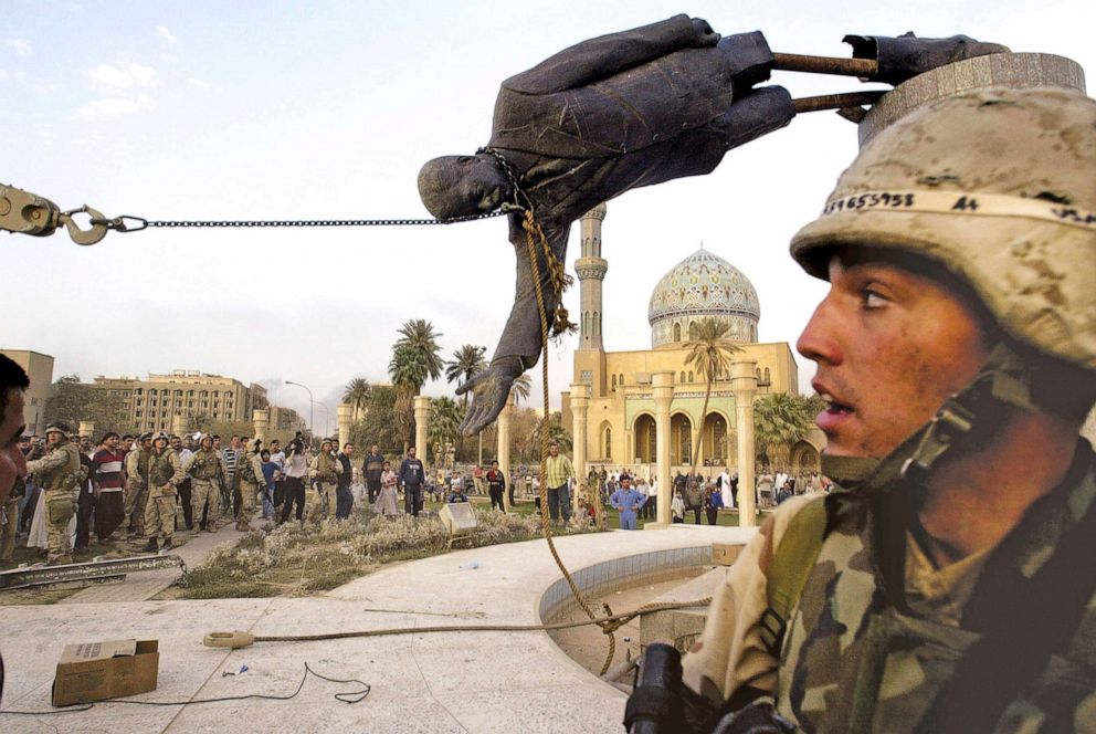 PHOTO: Iraqi civilians and U.S. soldiers pull down a statue of Saddam Hussein in downtown Baghdad, April 9, 2003.