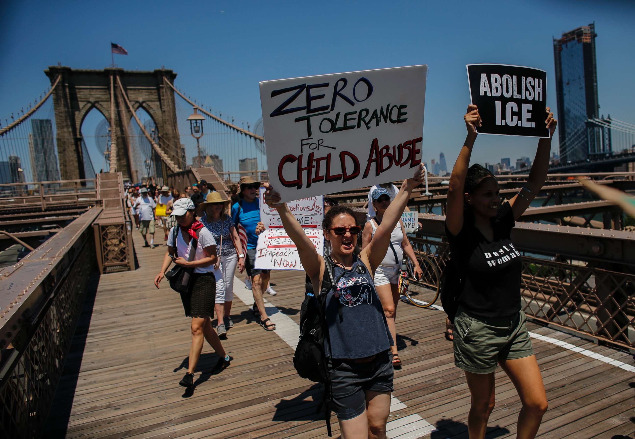 PHOTO: People take part during the nationwide "Families Belong Together" march as they walk by the Brooklyn Bridge on June 30, 2018 in New York City.