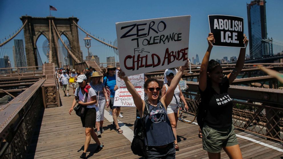 PHOTO: People take part during the nationwide "Families Belong Together" march as they walk by the Brooklyn Bridge on June 30, 2018 in New York City.