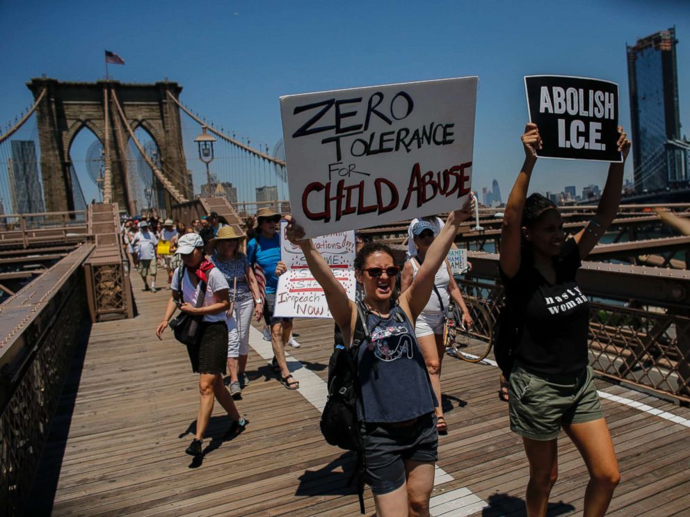 PHOTO: People take part during the nationwide Families Belong Together march as they walk by the Brooklyn Bridge on June 30, 2018 in New York City.