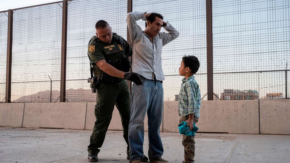 PHOTO: Jose, 27, with his son Jose Daniel, 6, is searched by US Customs and Border Protection Agent Frank Pino, May 16, 2019, in El Paso, Texas.