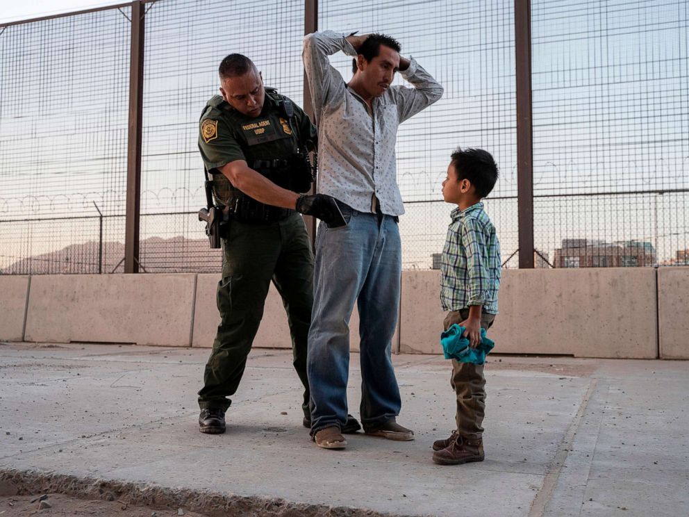 PHOTO: Jose, 27, with his son Jose Daniel, 6, is searched by US Customs and Border Protection Agent Frank Pino, May 16, 2019, in El Paso, Texas.