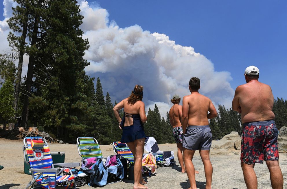 PHOTO: A family from Ventura County watches the billowing smoke from the Creek Fire from the shore of Shaver Lake, northeast of Fresno, California, on Sept. 5, 2020.