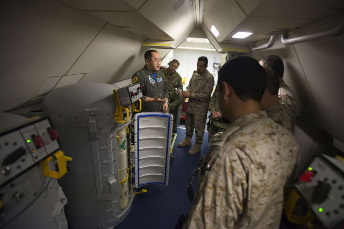 PHOTO: Lt. Fan Yang, left, a tactical coordinator assigned to Patrol Squadron (VP) 5, demonstrates the systems onboard a P-8A Poseidon aircraft to members of the Royal Saudi Naval Forces in an undisclosed location, March 1, 2018. 