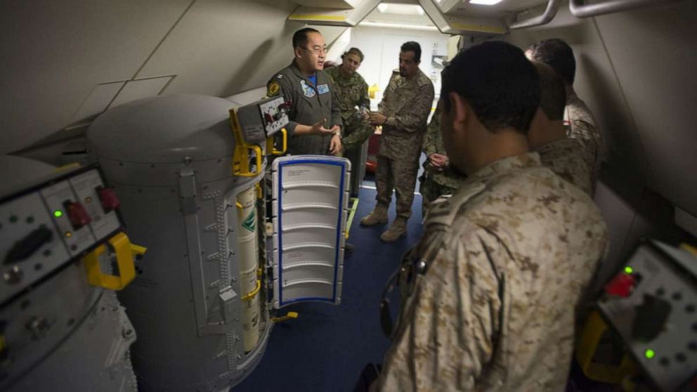 PHOTO: Lt. Fan Yang, left, a tactical coordinator assigned to Patrol Squadron (VP) 5, demonstrates the systems onboard a P-8A Poseidon aircraft to members of the Royal Saudi Naval Forces in an undisclosed location, March 1, 2018. 
