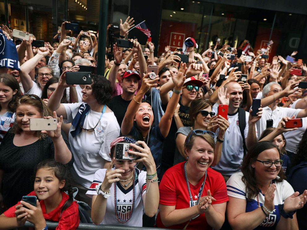PHOTO: Fans cheer as members of the U.S. Womens National Soccer Team travel down the Canyon of Heroes in a ticker tape parade, July 10, 2019, in New York City.