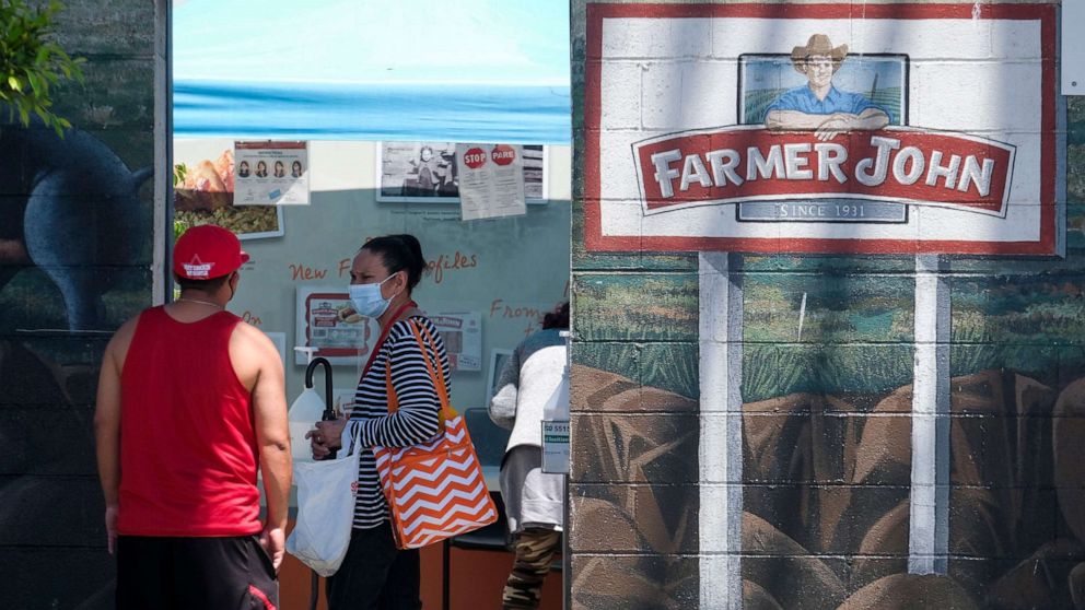 PHOTO: Workers are seen outside a Farmer John slaughterhouse May 21, 2020, in Vernon, Calif.